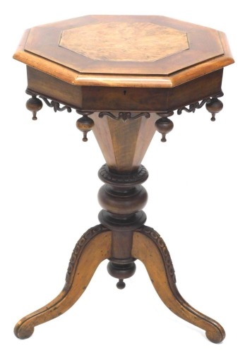 A Victorian walnut conical shaped work table, the octagonal hinged top with a later elm inlay enclosing a fitted interior with needlework accessories, the frieze with pierced and carved scrolls and drop finials on a part turned column, tripod base, 71cm h