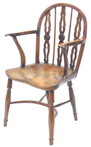 A 19thC yew ash and elm Windsor chair, the shaped back with pierced Gothic supports, embellished with roundels, with shaped arms, a solid seat, on turned legs with crinoline stretcher, possibly Lincolnshire. (AF)