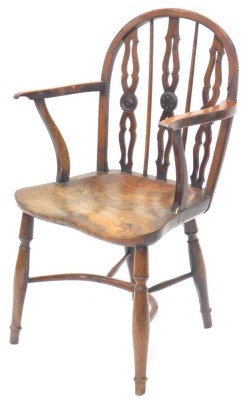 A 19thC yew ash and elm Windsor chair, the shaped back with pierced Gothic supports, embellished with roundels, with shaped arms, a solid seat, on turned legs with crinoline stretcher, possibly Lincolnshire. (AF)