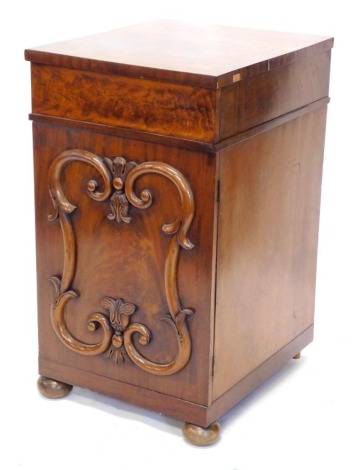 A 19thC mahogany pedestal cabinet, with a frieze drawer above a door with raised scroll and lappet carved panel, on bun feet, 97cm high, 56cm wide, 63cm deep.