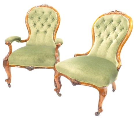 A pair of Victorian walnut show framed spoon back chairs, with green upholstered padded backs and seats, on cabriole legs, with casters, one with arms and a matching nursing chair. (2)