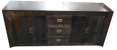 A large ebonised sideboard, with canted frieze and sides, three drawers and two pairs of doors, each with hinged brass handles, on a plinth, 87cm high, 200cm wide, 50cm deep.