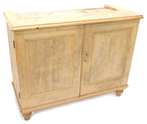 A pine cupboard, the top with a moulded edge, above two panelled doors enclosing a shelf, on bun feet, incomplete, 96cm high, 122cm wide, 53cm deep, and a laboratory stool. (2) The upholstery in this lot does not comply with the 1988 (Fire & Fire Furnishi