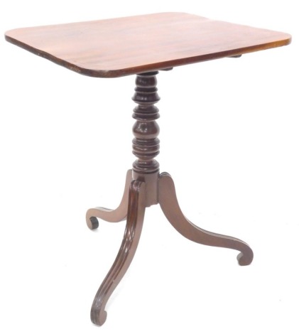 An early 19thC mahogany tilt top occasional table, the rectangular top with rounded corners on a turned column and scroll carved tripod base, 76cm high, the top 67cm x 57cm.