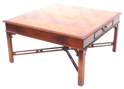 A mahogany coffee table, the square top with a cross banded border above a frieze drawer to each end, on channeled legs, 49cm high, the top 95cm x 95cm.