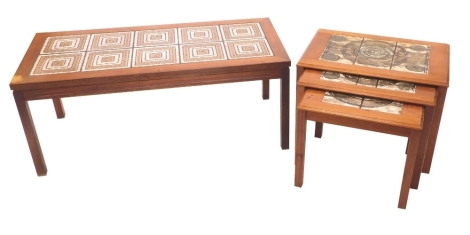 A nest of three Danish style teak occasional tables, each with a Studio tile top, on plain legs, the largest 45cm high, 63cm wide, and a similar coffee table with tile inserts, 46cm high, 112cm wide. (2, AF)