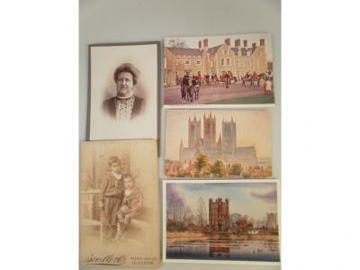 Two albums containing 19thC photographs and postcards including Lincoln