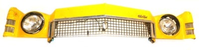 A Chevrolet Monte-Carlo yellow taxi car front bumper fascia, with two head lamps and front grille, in yellow, 175cm long.