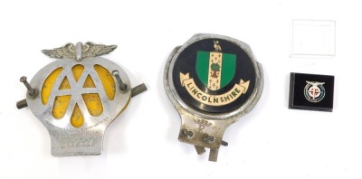 Car badges and lapel pin, comprising an AA car badge, no 2A48776, and Lincolnshire car badge, together with a BRM lapel pin, dated 1999. (AF) (3)