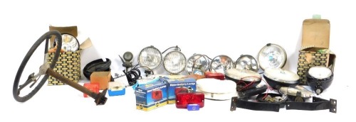 A group of motoring parts, comprising bulbs, indicator lights, head lamps, cased set, Citroen lamps, Butlers cased headlamps, steering wheel, etc. (2 boxes)