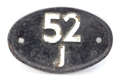 A cast railway sign, oval with cream numbers and cream details, 52 J, 19cm wide.