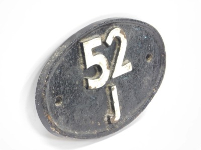 A cast railway sign, oval with cream numbers and cream details, 52 J, 19cm wide. - 2