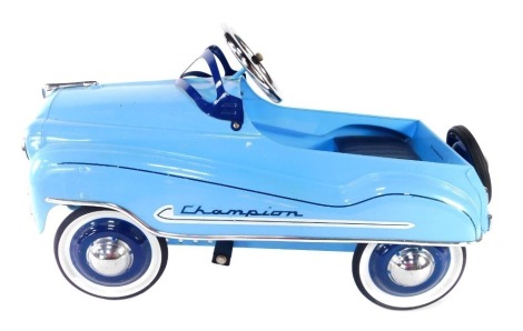 A reproduction Murray Champion pressed steel pedal car, in light blue.