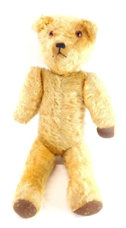 An early 20thC growler Teddy Bear, with beaded eyes and stitched snout, 61cm high. (AF)