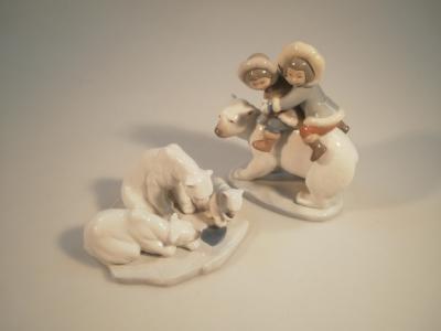 A Lladro figure of two Eskimo children riding on the back of a polar bear