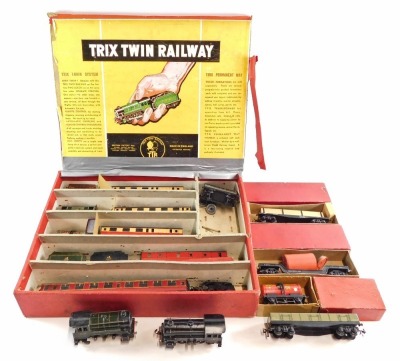 A Trix Twin Railway three rail locomotive and rolling stock, including 0-4-0 locomotive and tender, coaches, wagons, etc. (1 box and loose)