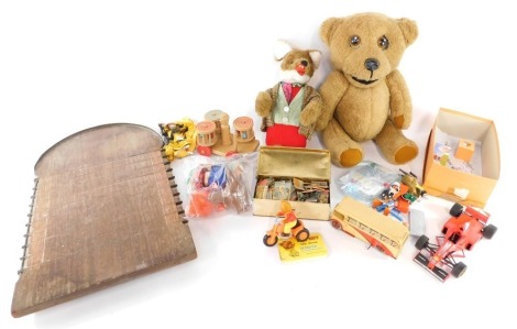 Soft toys and games, to include Rupert The Bear friction drive scooter, tin plate clockwork bus, shove halfpenny board, Basil Brush soft toy, etc. (1 box)