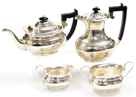 A George V silver four piece tea set, in the Georgian style, comprising teapot, hot water jug, cream jug and sugar bowl, Sheffield 1935, 59¼oz gross.