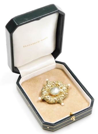 An Elizabeth Gage 18ct gold and green enamel 'Kiss Pin' brooch, set with a central oval raised and faceted cut pale green stone with mother of pearl back, 1.7cm wide, surrounded by diamonds and abstract gold leaf pattern raised highlights, each corner set