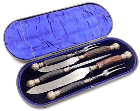 A Victorian carving set, comprising two pairs of forks and knives, the blades stamped James Deakin and Son, Cutlers Sheffield, with a part antler handle, in fitted case.