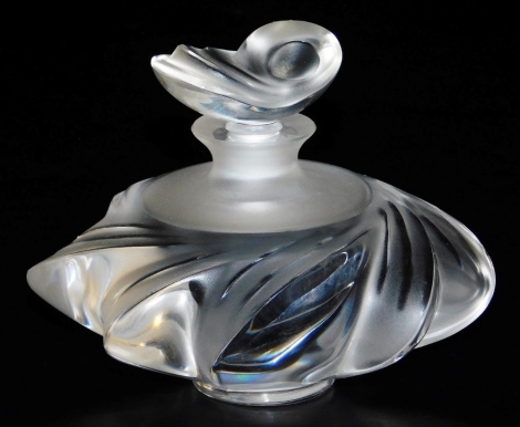 A Lalique Samoa glass scent bottle and stopper, the stopper modelled in the form of a shell, the bottle of lobed form, etched to underside Lalique, France, 8.5cm high, 9cm wide.