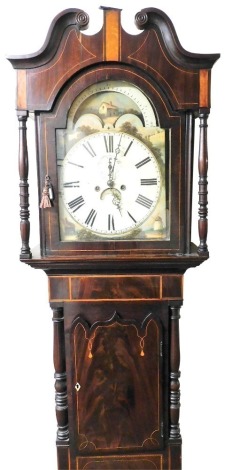 An early 19thC flame mahogany and boxwood inlaid longcase clock, the moon phase arched dial painted with cottages, windmill and castle, bearing Roman numerals, subsidiary seconds dial and date aperture, with eight day four pillar movement with coil strike