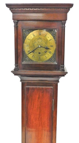 A mahogany cased grandmother clock, the circular brass dial with spandrels, chapter ring bearing Roman numerals, eight day movement with Westminster chime, the hood and case of plain architectural form, 169cm high, with key and pendulum.