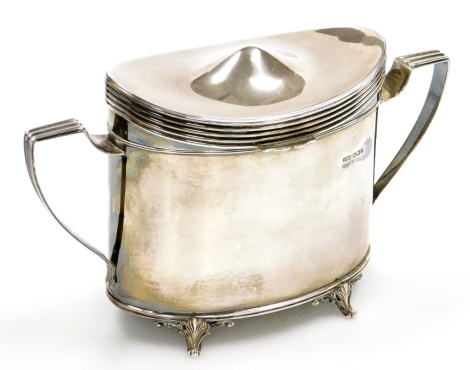 An Edwardian silver tea caddy, of oval form, with two angular handles, raised on four scroll cast feet, James Dixon, Sheffield 1908, 13.5cm high, 17¼oz.