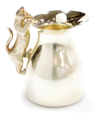 An Elizabeth II silver cream jug, the handle cast with a figure of a cat, Peter Nicholas and Co, London 1990, 8cm high, 4½oz.