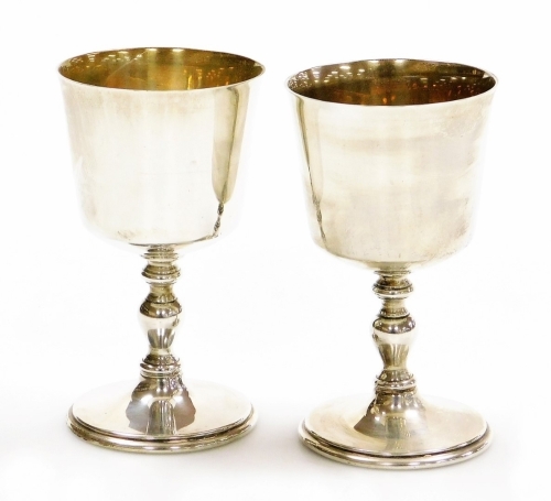 A pair of Elizabeth II silver goblets, of plain form, raised on baluster stems, Barker Ellis Silver Co, Birmingham 1977, 12cm high, 11¾oz.