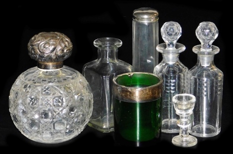 A Victorian cut glass scent bottle, of globular form with a silver repousse decorated stopper, Chester 1899, 15cm high, a pair of cut glass scent bottles, 16cm high, green glass jar with silver mount, Chester 1901, 8.5cm high, (AF), a dressing table jar, 