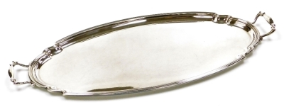 A silver plated two handled serving tray, of oval form with a shaped border, 59cm wide.