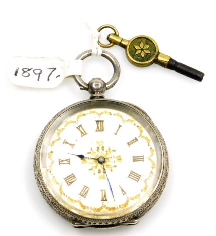 A late 19thC Swiss white metal pocket watch, open faced, key wind, the case decorated with scrolls, leaves, etc., around a rectangular vacant cartouche, the silver coloured dial with Roman numerals and gilt scroll embellishment to the centre and border, s