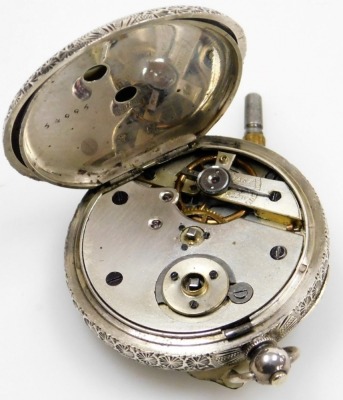 A late 19thC Swiss white metal pocket watch, open faced, key wind, decorated with leaves, flower heads, around a vacant cartouche, the white enamel dial with Roman numerals, within a gilt scroll border, the quarters marked with blue enamel dots, the case - 2