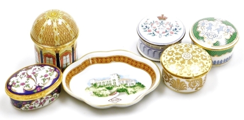 An enamelled circular music box for the music room at Buckingham Palace, playing Voi Che Sapete from Mozart's the Marriage Of Figaro, limited edition number 236/250, 7.5cm high, four porcelain lidded boxes, and a Reid's Palace pin tray, 11.5cm wide.