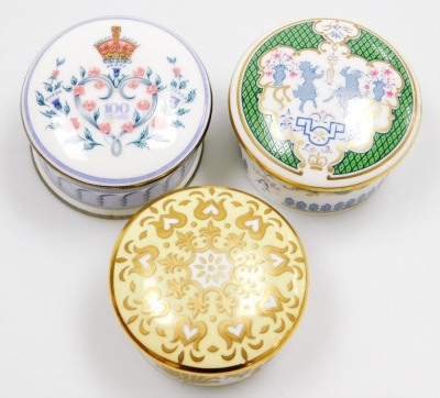 An enamelled circular music box for the music room at Buckingham Palace, playing Voi Che Sapete from Mozart's the Marriage Of Figaro, limited edition number 236/250, 7.5cm high, four porcelain lidded boxes, and a Reid's Palace pin tray, 11.5cm wide. - 2