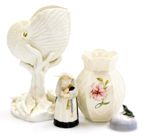 A Royal Worcester porcelain candle snuffer of a nun, 10cm high (AF), a Royal Copenhagen model of a frog on a lily pad, 5cm wide, a Belleek porcelain vase, decorated with a lily with raised hatched decoration, 11cm high, and a Royal Worcester porcelain nau