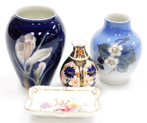 A Royal Copenhagen porcelain vase, decorated with an iris against a dark blue ground, 12cm high, a Royal Copenhagen baluster shaped small vase, decorated with flowers and blackberries against a graduated blue ground, 11cm high, a Royal Crown Derby Imari p