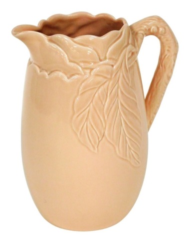 A Clarice Cliff pink glazed jug, decorated in relief with leaves, printed mark to underside for Newport Pottery, raised numbers 817, etc., 24cm high.