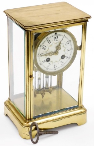 A late 19thC French gilt brass cased four glass mantel clock, the circular enamel dial bearing Arabic numerals and painted with rose swags, eight day movement with coil strike, number 3508 4 11, the case of carriage clock form with mercury pendulum and ke