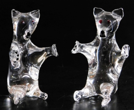 A pair of Victorian glass frigger bear ornaments, seated with open arms, with red dot eyes, 7cm high.