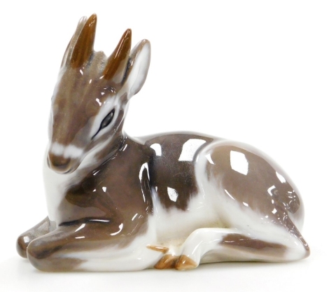 A Royal Copenhagen porcelain model of a recumbent fawn, printed marks, 11cm long.