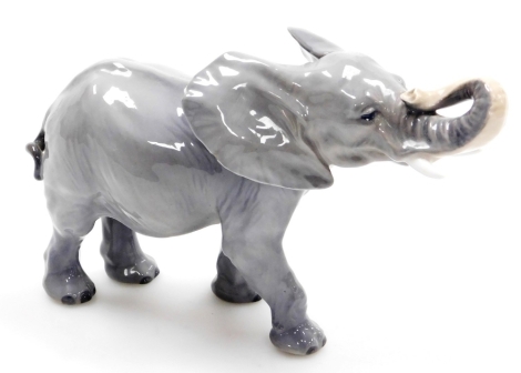 A Royal Copenhagen porcelain model of an elephant, printed marks, 15cm high.