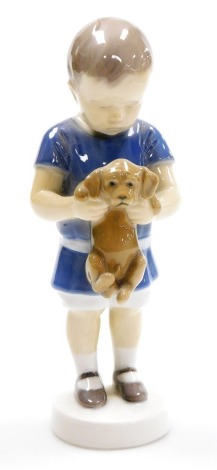 A Royal Copenhagen porcelain model of a boy with puppy, printed marks, 17.5cm high.