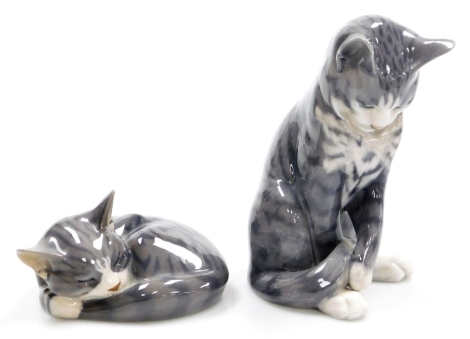 Two Royal Copenhagen porcelain models of cats, numbers 422 and 340, printed marks, the seated kitten 17.5cm high, and the sleeping kitten 14cm wide.