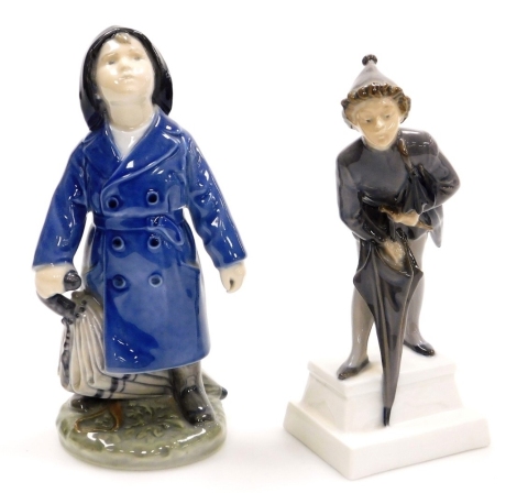 Two Royal Copenhagen porcelain figures of boys with umbrellas, number 3556 and 1129, printed marks, 19cm and 18cm high.