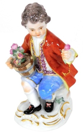 A 20thC Meissen porcelain figure of a boy, modelled seated with a pot of roses, on a rococo scroll base, blue crossed swords mark, 10.5cm high.