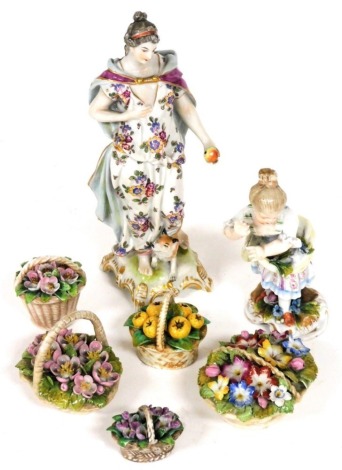 A Continental porcelain figure of a classical female, holding apples, a dog at her side, 15cm high, and a further continental porcelain figure of a girl, 10cm high, and five miniature porcelain encrusted flower baskets. (AF) (7)