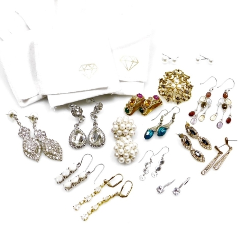 A group of silver and other dress earrings, comprising a pair of three stone set opal and silver drop earrings, multicoloured cluster earrings, clip on earrings, faux pearl beads, etc., and a costume jewellery brooch, approx fifteen pairs. (a quantity)