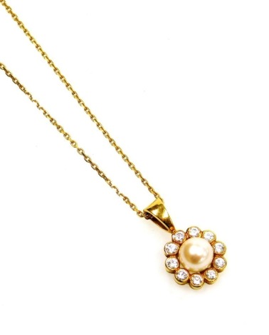 An 18ct gold pearl and diamond cluster pendant, with central cultured pearl surrounded by tiny diamonds in an 18ct gold setting, on a fine link neck chain, the pendant 2cm high, the chain 38cm long overall, 2.6g all in.